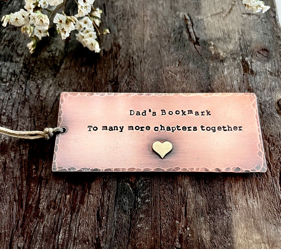 Handmade copper bookmark for Dad stamped with 'To many more chapters together' and finished with a brass heart detail.
