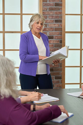 Maureen Kures in purple blazer leading an end of life workshop