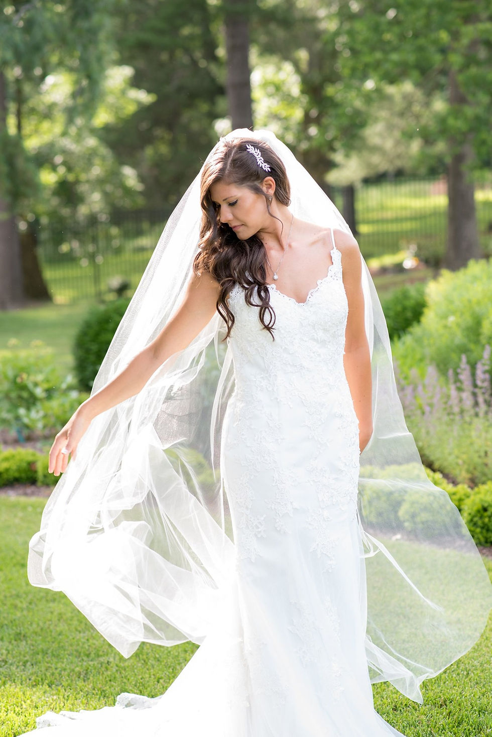 Bride at the Belmont Maonr and Historic park. Bride is spinning in the garden and her veil is swept out behind her