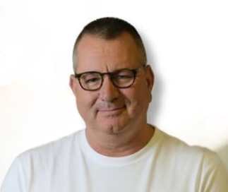 תמונת פרופיל של ניצן פלג,תמונה המציגה את ראשו וכתפיו, לובש משקפי ראייה עם מסגרת שחורה וחולצה לבנה