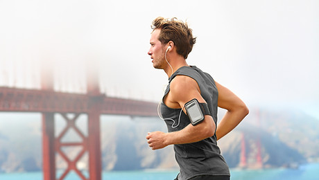 Man running with bridge in background