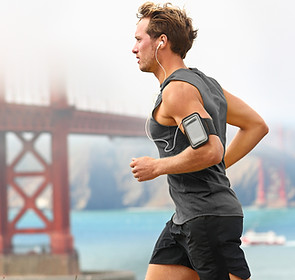 Man running with bridge in background