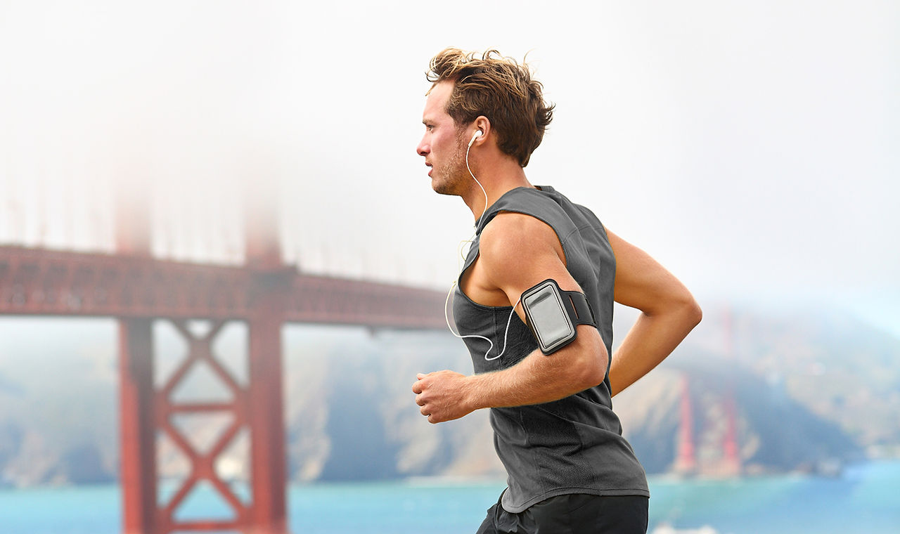 Man running with bridge in background