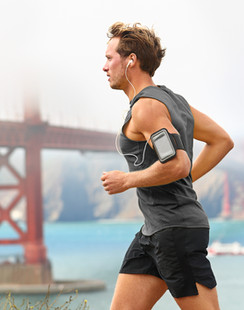 Man running with bridge in background