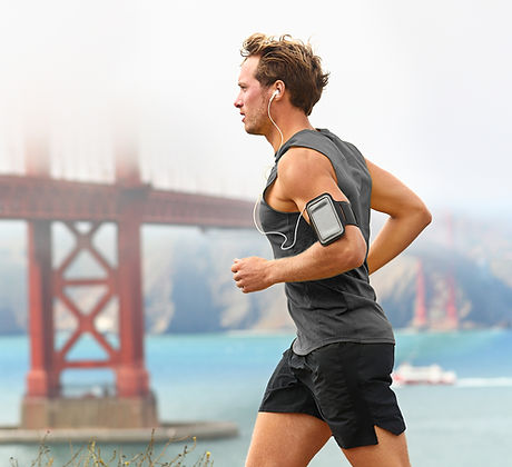 Man running with bridge in background