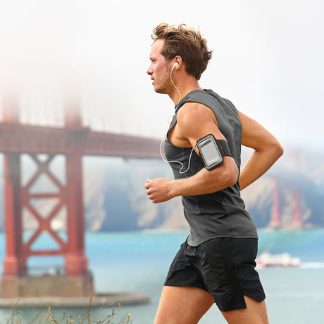 Fit man running outdoors with the Golden Gate Bridge in the background