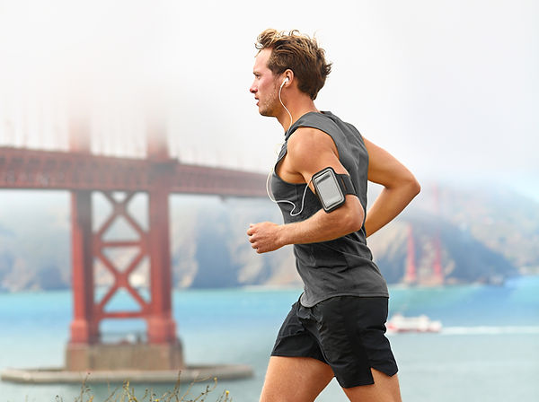 Man running with bridge in background