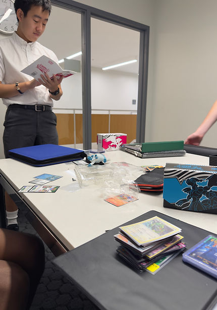 Pokémon club member reading Black Bolt card list