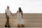 Kimberly shares a joyful moment with her fiancé on a sunny day, hand in hand on the steps at Kiley Garden in Tampa, Fl.