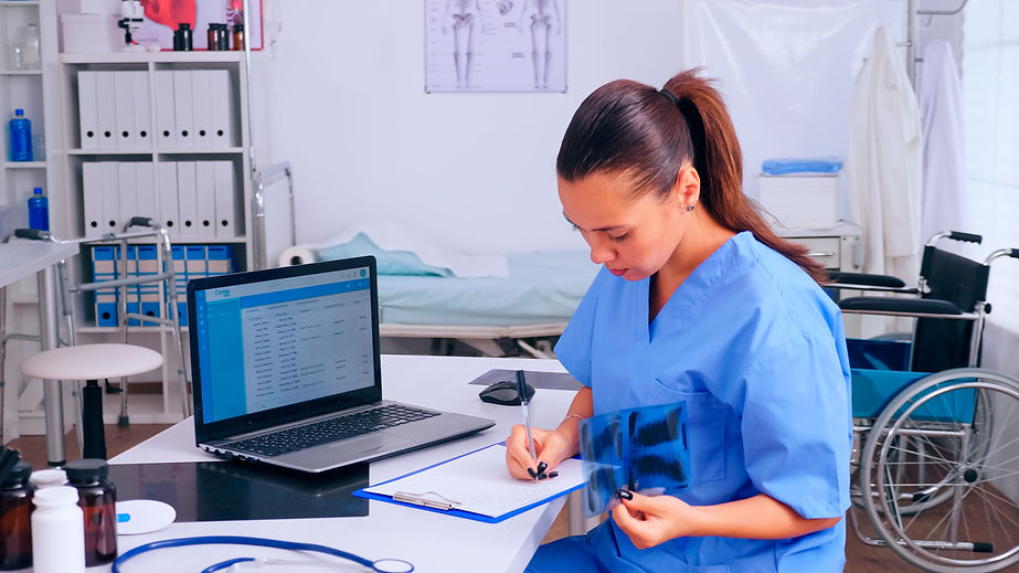 nurse-checking-x-ray-result-reading-patients-list-taking-notes-clipboard-holding-radiograp