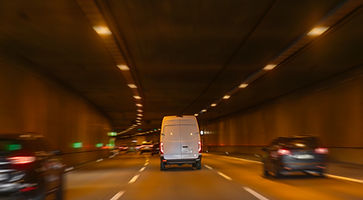 delivery-van-speeds-through-city-tunnel-night-traffic-motion.jpg