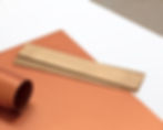 Modern level on table with orange and white paper
