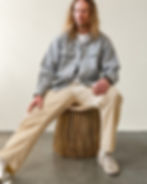 Designer Calen Knauf sitting on table that looks like a scrub brush