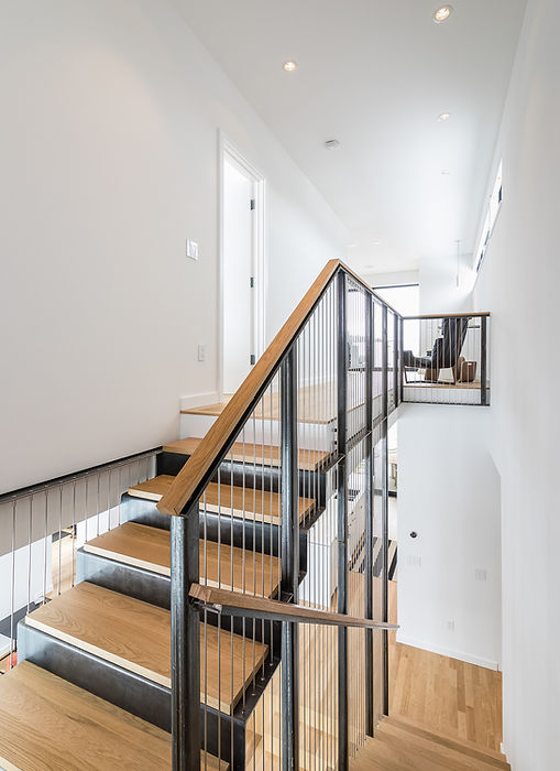 Minarik Architecture staircase metal suspension wood railings wood steps stairwell white walls modern house