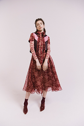 A look features a bodysuit, a silk dress, an organza dress, a leather top with a modern chevron print, and shoes
