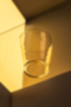 Clear drinking glass on amber background