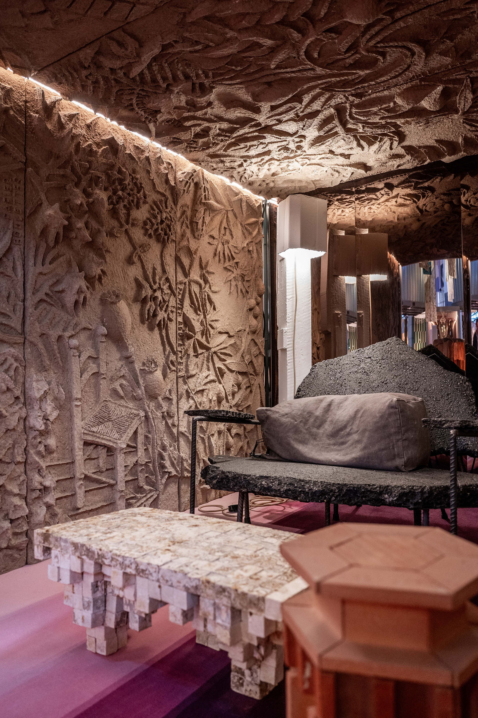 exhibit design with decorative benches and embossed walls