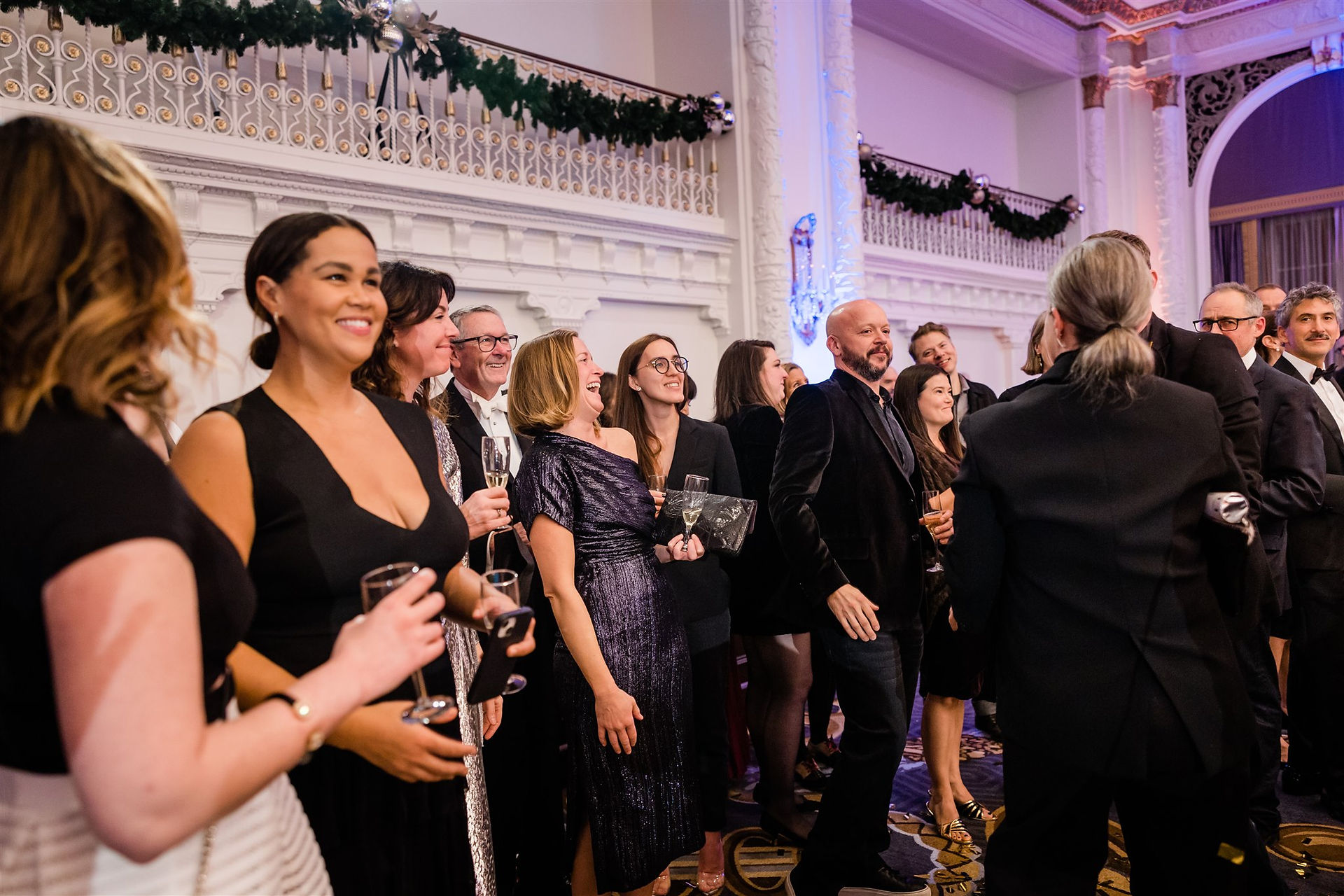 Party guests in ballroom at formal gala
