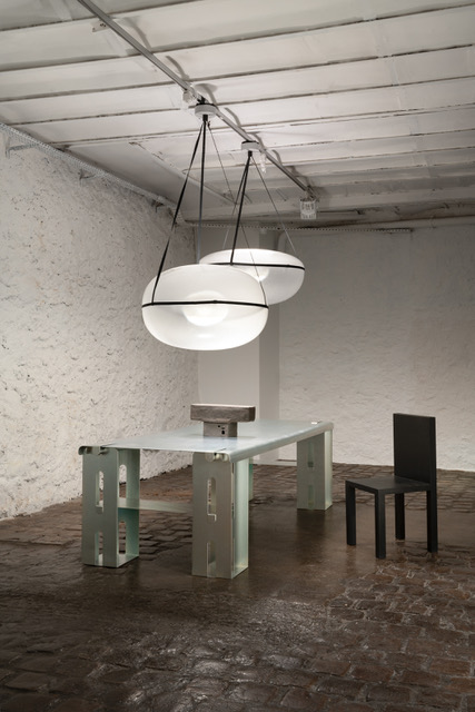 round pendant lights by andlight in a dining room setting