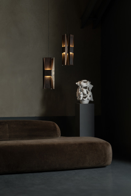 andlight pendant lights in brown room with velvet sofa