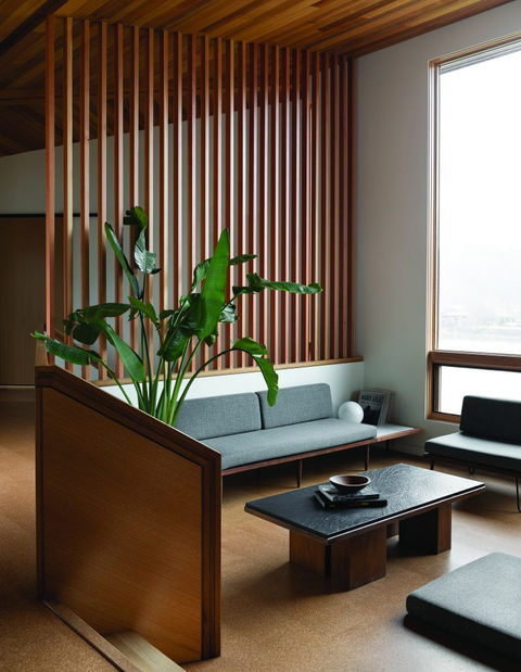 living room seating area with wood slat wall divider
