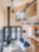 Interior loft of prefab cabin living room kitchen bedroom wood walls bifold window patio doors