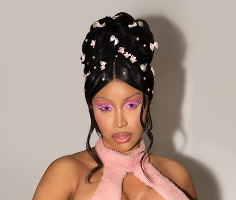 a woman with pink hair and pearls on her head