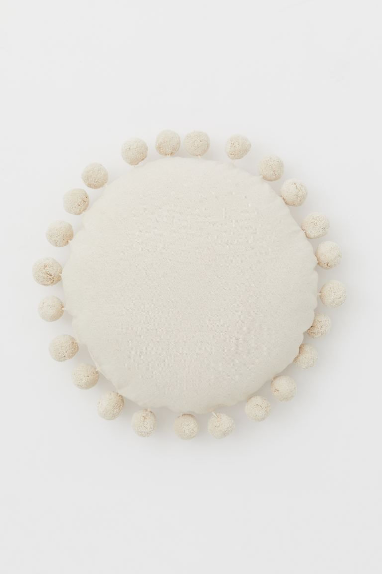 Rond kussen met pompons