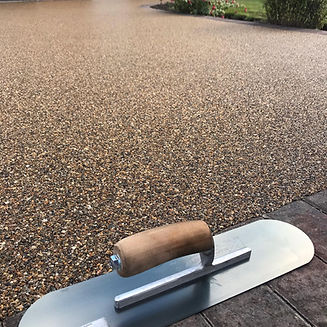 Close up of trowel on resin driveway