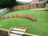A garden sectioned with newly laid grass