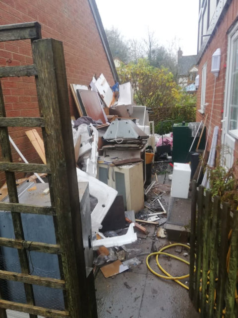 household waste at the side of a property