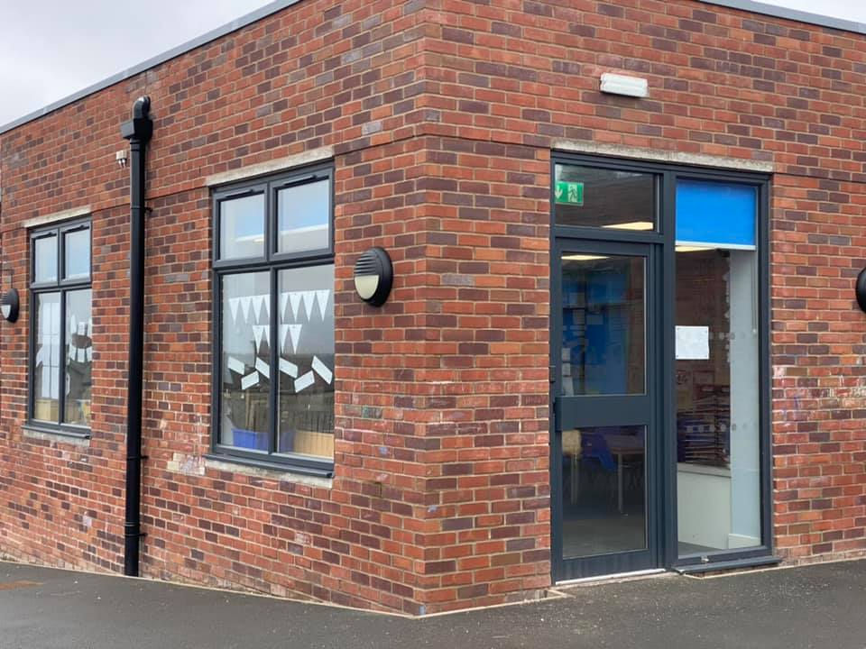 Black aluminium door and window matching in commercial property by Door Maintenance 2003 L