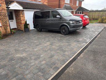 Large grey driveway with drainage