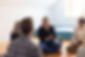 Group of people at a workshop, smiling and talking during the Bend Wellness workshop.