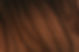 Close-up of dark brown wood grain texture with natural patterns and details.