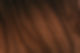Close-up of dark brown wood grain texture with natural patterns and details.
