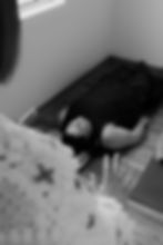 Individual lying on mat, receiving somatics guidance