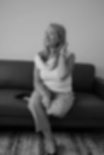 Black and white photo of a woman on a couch