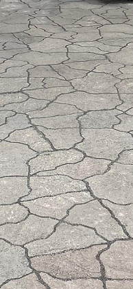 Before and after of apatio that has been cleaned of weeds.