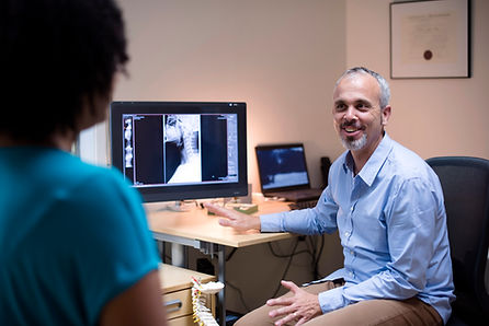 Doctor reviewing medical scans with patient