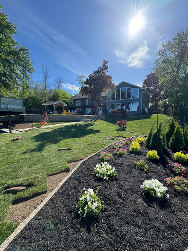sod install, planting, lawn trimming, lawn mowing, black mulch, planting, stone edging installed for mulch bed