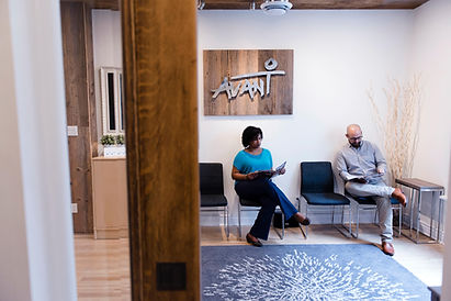 Two people waiting in a modern office reception area