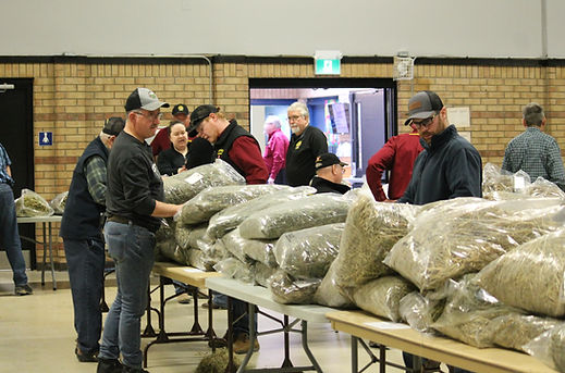 People looking at bags of grain