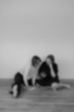 Two women on floor, one laughing, one looking down