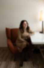 Woman sitting in an armchair looking to the side