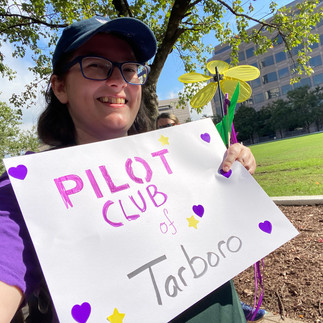 Woman holding Pilot Club of Tarboro sign