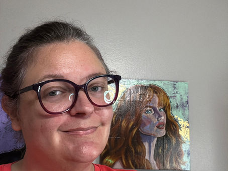 Karen Atkins with a portrait painting.