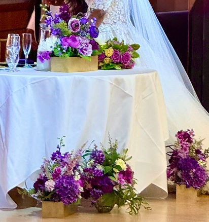 purple centerpieces and floral boxes