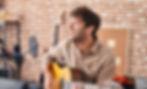 Young man musician singing song playing classical guitar at music studio_edited_edited.jpg