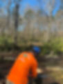 man holding chainsaw rear view.jpeg